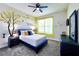 Cheerful bedroom with a navy bed frame, yellow accents, and unique wall decor at 8974 Cabot Cliffs Dr, Davenport, FL 33896