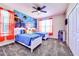 A bedroom featuring two twin beds, blue comforters, and an ocean themed mural at 8974 Cabot Cliffs Dr, Davenport, FL 33896
