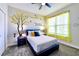 Stylish bedroom with a leafy tree wall decal and bright yellow accents at 8974 Cabot Cliffs Dr, Davenport, FL 33896