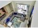 A large sectional sofa with blue accents in a naturally illuminated living room, overhead view at 8974 Cabot Cliffs Dr, Davenport, FL 33896