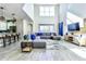 Bright and airy living room with stylish sectional sofa, high ceilings, and modern decor at 8974 Cabot Cliffs Dr, Davenport, FL 33896