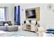 Bright living room featuring a gray sectional sofa, modern media console, and stylish decor at 8974 Cabot Cliffs Dr, Davenport, FL 33896