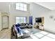 Spacious living room with high ceilings, large windows, comfortable sectional seating and stylish contemporary decor at 8974 Cabot Cliffs Dr, Davenport, FL 33896