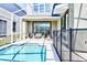 Private screened-in pool with a safety fence and outdoor seating area at 8974 Cabot Cliffs Dr, Davenport, FL 33896
