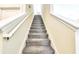 Carpeted staircase with white railings leading to the upper level of the home at 8974 Cabot Cliffs Dr, Davenport, FL 33896