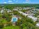 Aerial view showcasing the pool, community buildings, green spaces, and residential architecture in this community at 920 Spring Park St # 301, Celebration, FL 34747