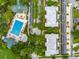 Aerial view of the community with mature trees, community pool, ample parking, and green space at 920 Spring Park St # 301, Celebration, FL 34747