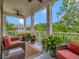 Balcony featuring comfortable wicker furniture and serene treetop views at 920 Spring Park St # 301, Celebration, FL 34747