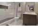 Bathroom featuring a walk-in shower with decorative tile and a gray vanity with a white countertop at 920 Spring Park St # 301, Celebration, FL 34747
