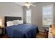 Bedroom with hardwood floors, ceiling fan, and abundant light from two windows with plantation shutters at 920 Spring Park St # 301, Celebration, FL 34747