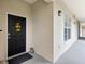 Welcoming entrance with black door, sunflower wreath, and a stone accent, creating a cozy first impression at 920 Spring Park St # 301, Celebration, FL 34747