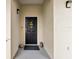 Apartment entryway with black door and welcome wreath, offering a touch of charm at 920 Spring Park St # 301, Celebration, FL 34747