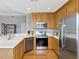 Well-lit kitchen featuring stainless steel appliances, wood cabinets, and ample counter space at 920 Spring Park St # 301, Celebration, FL 34747