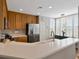 Bright kitchen features wood cabinets, stainless steel appliances, and a breakfast bar at 920 Spring Park St # 301, Celebration, FL 34747