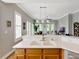 Open kitchen with views to the living room, doors to patio, and bright natural light at 920 Spring Park St # 301, Celebration, FL 34747