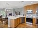 Open kitchen boasts wood floors, stainless appliances and flows into the dining and living area at 920 Spring Park St # 301, Celebration, FL 34747