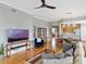 Open-concept living room with wood floors adjacent to the kitchen and dining area at 920 Spring Park St # 301, Celebration, FL 34747