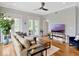 Bright living room featuring wood floors, large windows, and access to a balcony at 920 Spring Park St # 301, Celebration, FL 34747