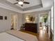 Bedroom with beautiful ceiling detail, bathroom, and balcony access at 920 Spring Park St # 301, Celebration, FL 34747