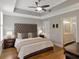 Elegant main bedroom features tray ceilings and ensuite bathroom entrance at 920 Spring Park St # 301, Celebration, FL 34747