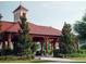 Beautiful covered pavilion with a red tile roof, lush landscaping, and sidewalks at 920 Spring Park St # 301, Celebration, FL 34747