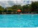 Close-up of the community pool with chairs and umbrellas, creating an inviting space for residents at 920 Spring Park St # 301, Celebration, FL 34747