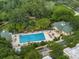 Aerial view of the pool area with chairs, tables, and surrounding greenery, part of a well-maintained community at 920 Spring Park St # 301, Celebration, FL 34747