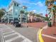A bustling street view in an active city with commercial buildings, palm trees, and festive holiday decorations at 920 Spring Park St # 301, Celebration, FL 34747