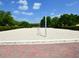 Well-maintained sand volleyball court surrounded by lush landscaping and trees at 920 Spring Park St # 301, Celebration, FL 34747