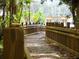 Wooden walking bridge with natural wooden guardrails featuring dappled light and mature green trees at 920 Spring Park St # 301, Celebration, FL 34747