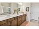 Bathroom featuring double sinks, a large mirror, ample cabinetry and a glass enclosed walk in shower at 1895 Spring Shower Cir, Kissimmee, FL 34744