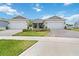 A well-maintained home featuring a three-car garage, manicured lawn, and inviting curb appeal at 1895 Spring Shower Cir, Kissimmee, FL 34744