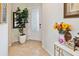 Inviting foyer featuring tiled floors, a decorative front door, a large fig tree and other decor at 1895 Spring Shower Cir, Kissimmee, FL 34744