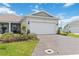 Charming home featuring an attached two car garage, manicured lawn, and a beautiful brick paver driveway at 1895 Spring Shower Cir, Kissimmee, FL 34744