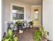Cozy front porch adorned with brick pavers, comfortable seating, potted plants, and a bright yellow front door at 1895 Spring Shower Cir, Kissimmee, FL 34744