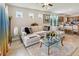 Well-lit living room featuring a comfortable couch, modern decor, and tile floors at 1895 Spring Shower Cir, Kissimmee, FL 34744