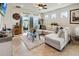 Comfortable living room featuring a large couch, glass coffee table, and sliding glass doors at 1895 Spring Shower Cir, Kissimmee, FL 34744
