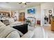 Open-concept living room features a comfortable couch, modern decor, and a view of the kitchen at 1895 Spring Shower Cir, Kissimmee, FL 34744