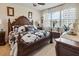 Warm and cozy main bedroom featuring a large bed, elegant furniture, and natural light at 1895 Spring Shower Cir, Kissimmee, FL 34744
