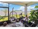 Enclosed patio featuring comfortable seating, a swing chair, and views of the fenced backyard at 1895 Spring Shower Cir, Kissimmee, FL 34744
