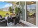 Relaxing covered patio with comfortable seating, a dining set, and sliding glass doors to the interior at 1895 Spring Shower Cir, Kissimmee, FL 34744