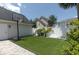 Backyard featuring a basketball hoop, artificial turf, and a white fence at 1236 Aquila Loop, Celebration, FL 34747
