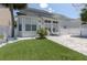 Serene backyard includes a pool, lush greenery, patio, and white fencing, providing a private oasis for outdoor enjoyment at 1236 Aquila Loop, Celebration, FL 34747