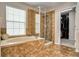 Bathroom showcasing a tub, glass shower, tile flooring, and a walk in closet at 1236 Aquila Loop, Celebration, FL 34747