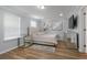 Comfortable bedroom with a light color scheme, mirrored nightstands, and a plush upholstered headboard at 1236 Aquila Loop, Celebration, FL 34747