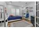 Comfortable bedroom featuring a vibrant color scheme, ample shelving for decor, and natural light at 1236 Aquila Loop, Celebration, FL 34747