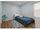 Bright bedroom with wood floors, a single bed and a chair at 1236 Aquila Loop, Celebration, FL 34747