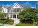 Charming two-story home featuring a welcoming porch and a well-maintained landscaped yard at 1236 Aquila Loop, Celebration, FL 34747