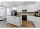Modern kitchen with white cabinets, stainless appliances, and granite counters is perfect for cooking and entertaining guests at 1236 Aquila Loop, Celebration, FL 34747