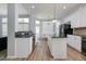 Spacious kitchen with stainless steel appliances, white cabinets, and a large island provides ample space for meal preparation at 1236 Aquila Loop, Celebration, FL 34747